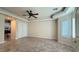 Bright bedroom with marble floors, plantation shutters, and a ceiling fan at 8821 Sandspring Dr, Las Vegas, NV 89134