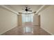 Spacious bedroom with marble flooring, plantation shutters, and a ceiling fan at 8821 Sandspring Dr, Las Vegas, NV 89134