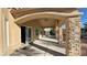 Covered patio with stone columns and ceiling fan at 8821 Sandspring Dr, Las Vegas, NV 89134