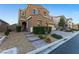 Two story house with a landscaped front yard, brick walkway, and two-car garage at 8853 Sherborne Gate Ave, Las Vegas, NV 89148