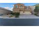 Two-story house with a landscaped front yard, brick walkway, and two-car garage at 8853 Sherborne Gate Ave, Las Vegas, NV 89148