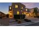 Two-story house with a landscaped front yard, brick walkway, and two-car garage at dusk at 8853 Sherborne Gate Ave, Las Vegas, NV 89148