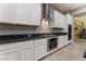 Modern kitchen with white cabinets, stainless steel appliances, and granite countertops at 8853 Sherborne Gate Ave, Las Vegas, NV 89148