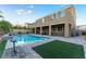 Luxury backyard with a sparkling pool and artificial turf at 8853 Sherborne Gate Ave, Las Vegas, NV 89148