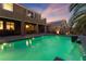 Stunning pool and patio area with a water feature and attractive lighting at 8853 Sherborne Gate Ave, Las Vegas, NV 89148