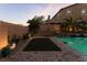 Relaxing backyard with putting green, pool, and decorative landscaping at 8853 Sherborne Gate Ave, Las Vegas, NV 89148