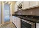 Wet bar with wine rack, beverage fridge, and granite countertop at 8853 Sherborne Gate Ave, Las Vegas, NV 89148