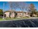 Single-story home with beige exterior, landscaping, and a large front yard at 9316 Provence Garden Ln, Las Vegas, NV 89145