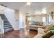 Living room with hardwood floors, staircase, and view into kitchen at 9462 Diamond Bridge Ave, Las Vegas, NV 89166