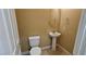 Small bathroom with pedestal sink and toilet at 9490 Alma Ridge Ave, Las Vegas, NV 89178