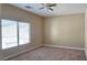 Spacious bedroom with large window and ceiling fan at 9490 Alma Ridge Ave, Las Vegas, NV 89178