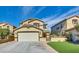 Two-story house with attached garage and landscaped lawn at 9516 Walking Spirit Ct, Las Vegas, NV 89129