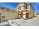 Two-story house with red door and decorative landscaping at 9516 Walking Spirit Ct, Las Vegas, NV 89129