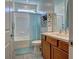 Simple bathroom with a bathtub, shower, and wood vanity at 9577 Among Ln, Las Vegas, NV 89143