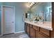 Modern bathroom with double vanity and wood cabinets at 9577 Among Ln, Las Vegas, NV 89143