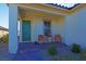 Inviting front porch with green door and seating area at 9577 Among Ln, Las Vegas, NV 89143