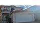 Two-story house with attached garage and landscaping at , Las Vegas, NV 89183