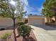 House exterior with two-car garage and landscaping at 10065 Hemet Dr, Las Vegas, NV 89134