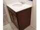 Dark wood vanity with single sink in a bathroom at 1023 Desert Dome Ave, North Las Vegas, NV 89086