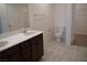 Double vanity bathroom with tiled flooring and walk-in closet at 1023 Desert Dome Ave, North Las Vegas, NV 89086