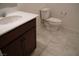 Small bathroom with dark wood vanity and toilet at 1023 Desert Dome Ave, North Las Vegas, NV 89086