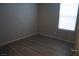 Simple bedroom with wood laminate flooring and window at 1023 Desert Dome Ave, North Las Vegas, NV 89086