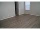 Spacious bedroom with wood-look floors and access to bathroom at 1023 Desert Dome Ave, North Las Vegas, NV 89086