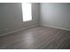 Bright bedroom with neutral walls and wood-look flooring at 1023 Desert Dome Ave, North Las Vegas, NV 89086