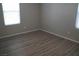 Well-lit bedroom with neutral walls and wood-look flooring at 1023 Desert Dome Ave, North Las Vegas, NV 89086