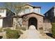 Two-story house with stone accents and a welcoming front porch at 1023 Desert Dome Ave, North Las Vegas, NV 89086