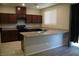 Modern kitchen with granite countertops and dark wood cabinets at 1023 Desert Dome Ave, North Las Vegas, NV 89086