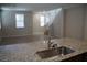 Kitchen with granite countertops, island, and view into living room at 1023 Desert Dome Ave, North Las Vegas, NV 89086