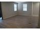 Bright living room with wood-look flooring and neutral walls at 1023 Desert Dome Ave, North Las Vegas, NV 89086