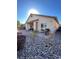 Backyard view showcasing a covered patio and a rock-covered landscape at 10328 Planter Box St, Las Vegas, NV 89178