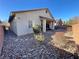 Landscaped backyard with gravel and a covered patio area at 10328 Planter Box St, Las Vegas, NV 89178