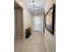 Bright and spacious entryway with tile flooring and a modern chandelier at 10328 Planter Box St, Las Vegas, NV 89178