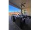 Covered patio with seating area, ceiling fan, and a view of the backyard at 10328 Planter Box St, Las Vegas, NV 89178