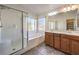 Elegant bathroom with double vanity, soaking tub, and shower at 10546 Hartford Hills Ave, Las Vegas, NV 89166