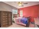 Well-lit bedroom with a coral accent wall at 10546 Hartford Hills Ave, Las Vegas, NV 89166