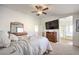 Bright bedroom featuring a large TV and ensuite bathroom at 10546 Hartford Hills Ave, Las Vegas, NV 89166