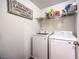 Laundry room with washer, dryer, and overhead shelving at 10546 Hartford Hills Ave, Las Vegas, NV 89166