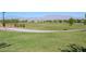 Open green space perfect for recreation with paved pathway at 10546 Hartford Hills Ave, Las Vegas, NV 89166