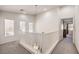 Upstairs hallway with white railing and natural light at 10546 Hartford Hills Ave, Las Vegas, NV 89166