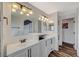 Double vanity bathroom with white cabinets and stone tile at 10809 Garden Mist Dr Dr # 2041, Las Vegas, NV 89135