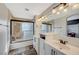 Double vanity bathroom with white cabinets and stone tile at 10809 Garden Mist Dr Dr # 2041, Las Vegas, NV 89135