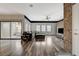 Living room with wood floors, brick accent wall, and sliding doors to balcony at 10809 Garden Mist Dr Dr # 2041, Las Vegas, NV 89135