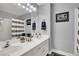 Double sink bathroom with striped shower curtain and grey walls at 1138 Aspen Valley Ave, Las Vegas, NV 89123