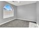 Bright bedroom with arched window, ceiling fan and grey walls at 1138 Aspen Valley Ave, Las Vegas, NV 89123