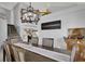 Bright dining room with a modern chandelier and staircase at 1138 Aspen Valley Ave, Las Vegas, NV 89123