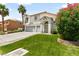 Two-story house with a three-car garage and lush green lawn at 1138 Aspen Valley Ave, Las Vegas, NV 89123